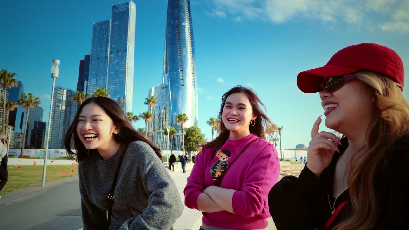 A GracePath consultant chatting with students near the harbourfront
